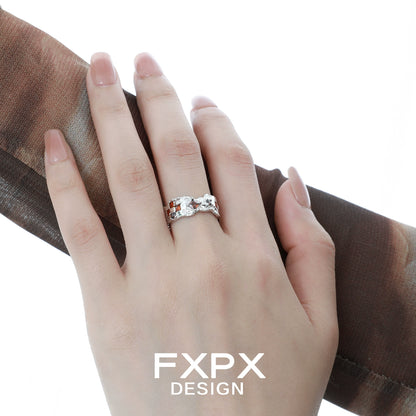 Elegant brown checkerboard silver ring displayed on a hand with a stylish scarf