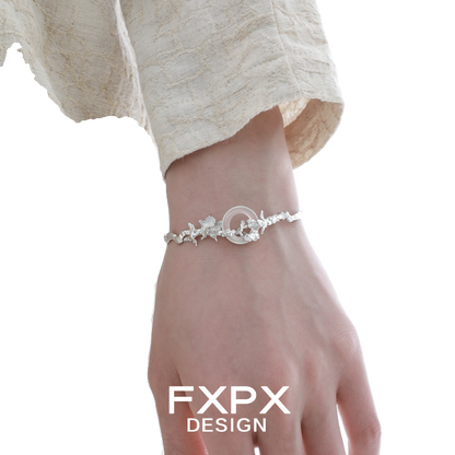 FXPX butterfly sigil bracelet in silver with intricate floral detailing worn on a wrist