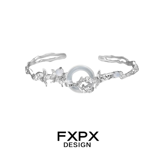 Elegant FXPX butterfly sigil bracelet featuring intricate floral designs and a central gemstone