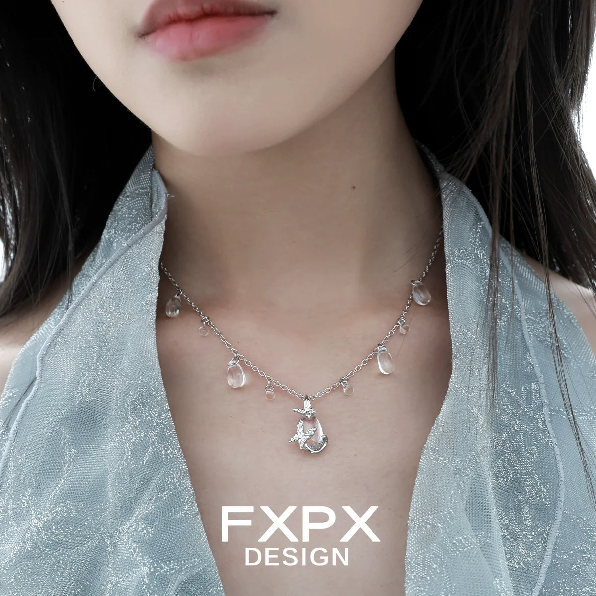 Stylish butterfly water drop silver necklace featuring delicate charms and a shimmering design