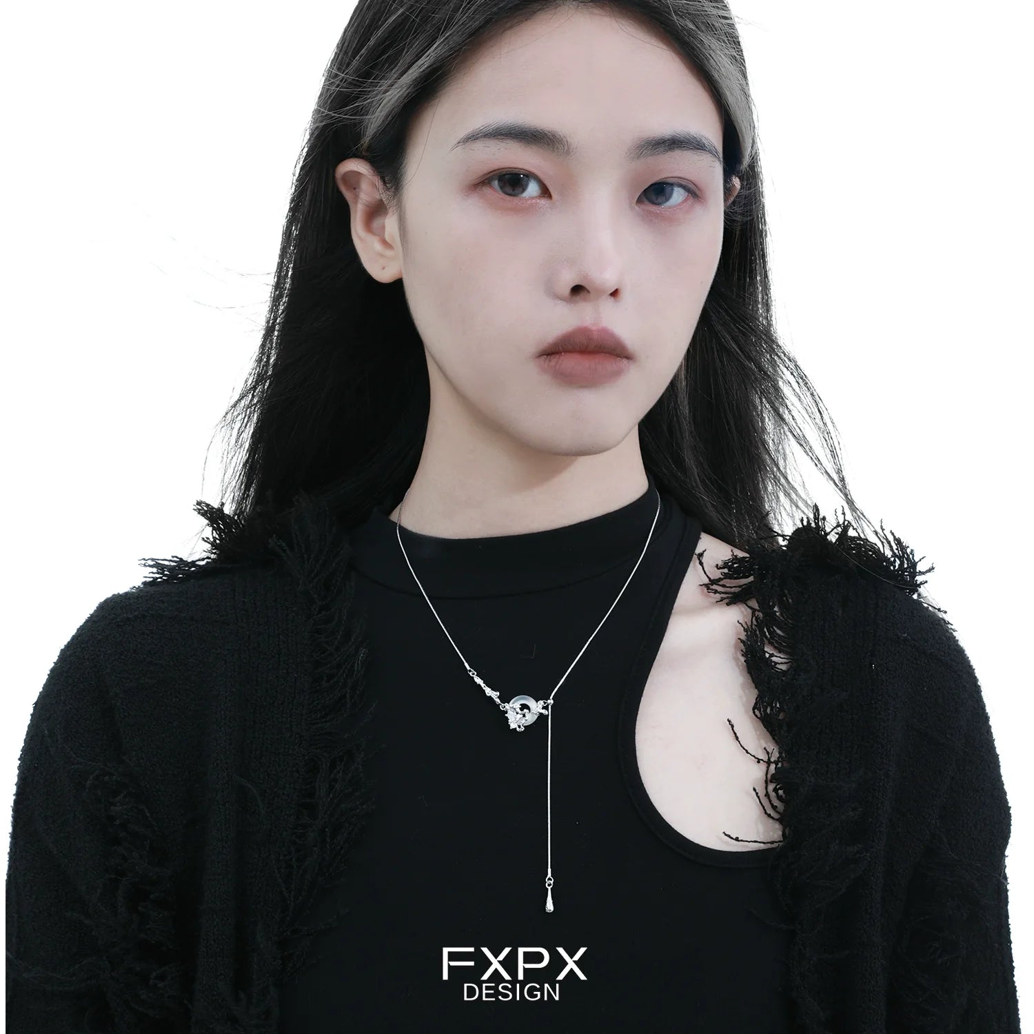 Fashion model wearing a celestial eclipse agate necklace in a sleek design and modern aesthetic