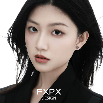 Elegant woman wearing colorful zircon stud earrings that add a vibrant touch to her look