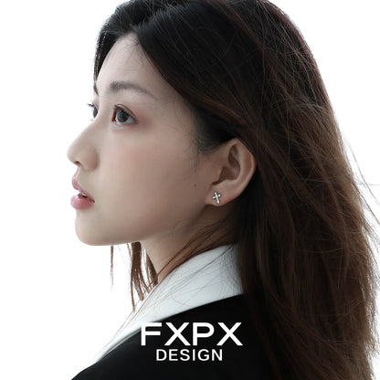 Elegant FXPX cross zircon earrings showcased on a model with sleek hair and natural makeup