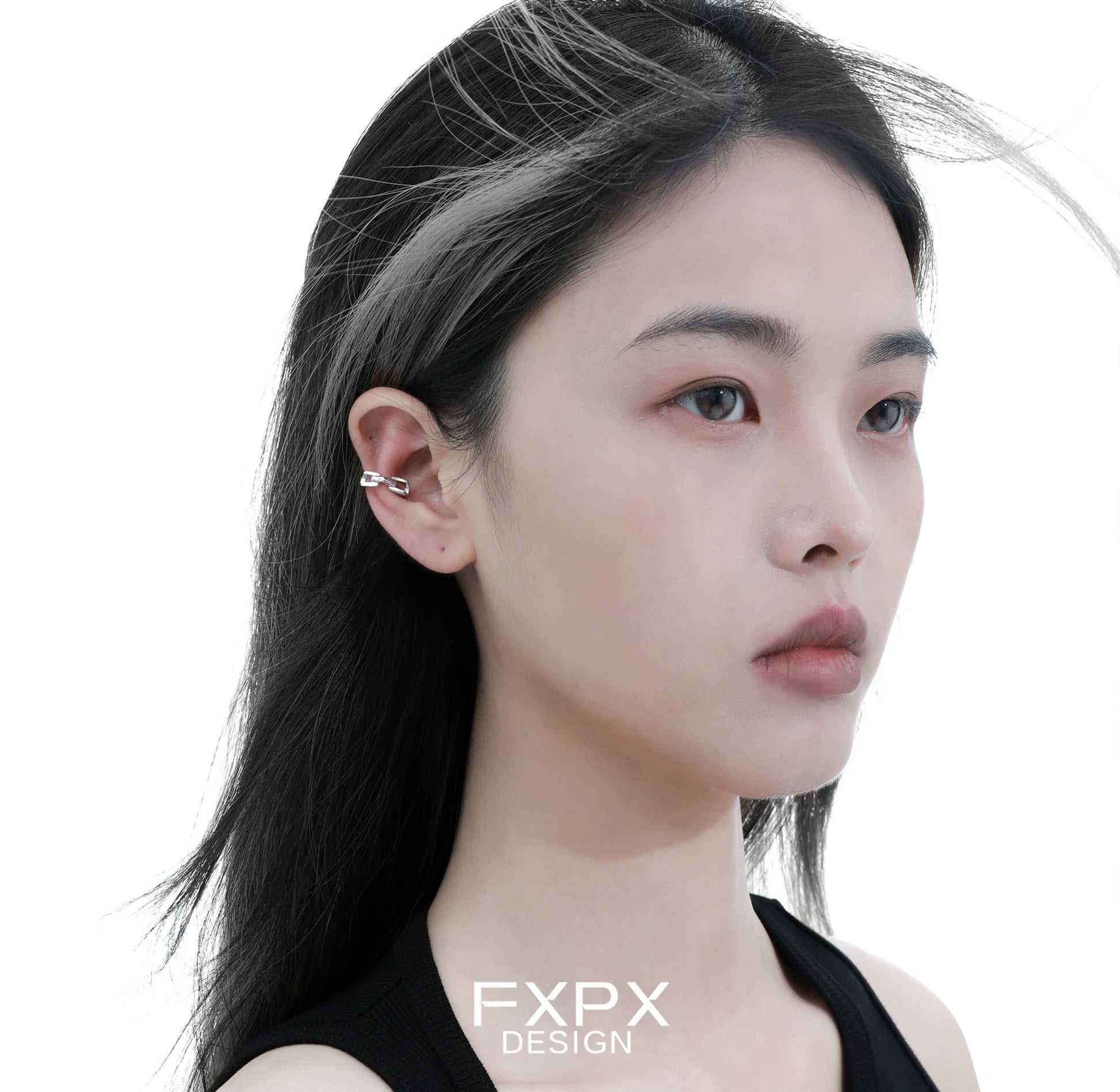 FXPX cyber mech silver earrings worn by a model with sleek, modern hairstyle and a minimalist style