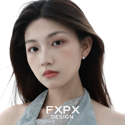 Elegant mirror butterfly silver earrings showcased on a model with long hair and natural makeup