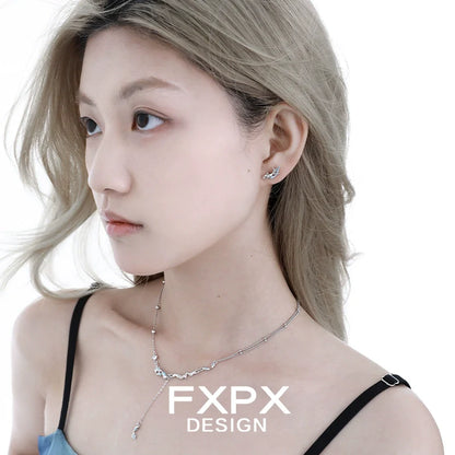 Stylish FXPX mystic mermaid earrings featured on model with long hair and chic attire