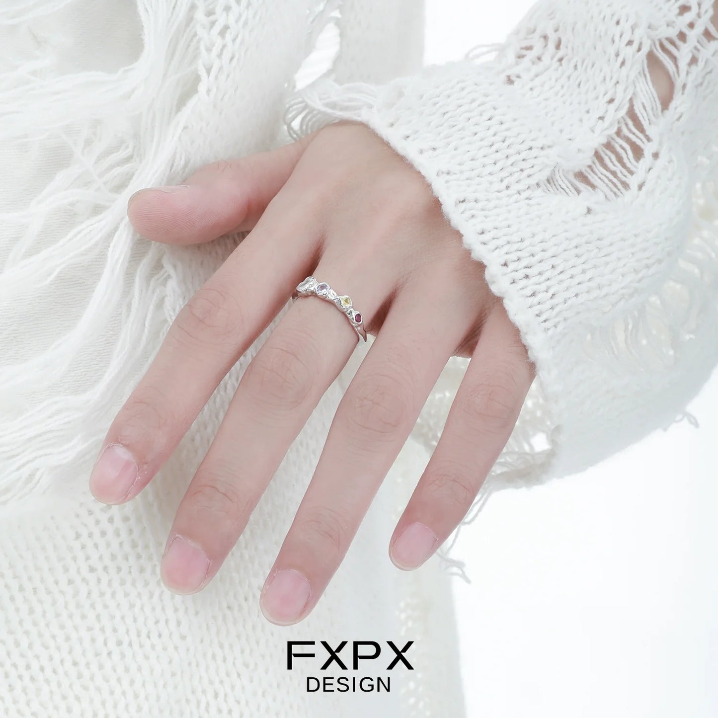Elegant FXPX dopamine colored zircon ring showcased on a hand with a stylish white sweater
