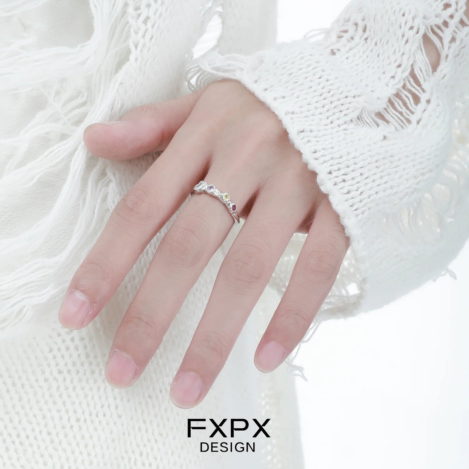 Elegant FXPX dopamine colored zircon ring showcased on a hand with a stylish white sweater