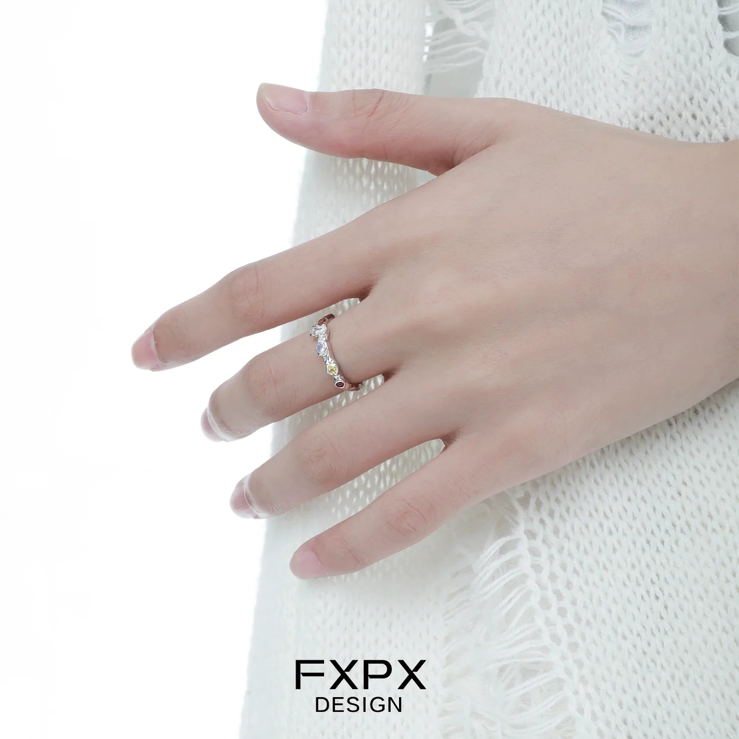 Elegantly displayed dopamine colored zircon ring on a hand, showcasing vibrant gemstones for a stylish look