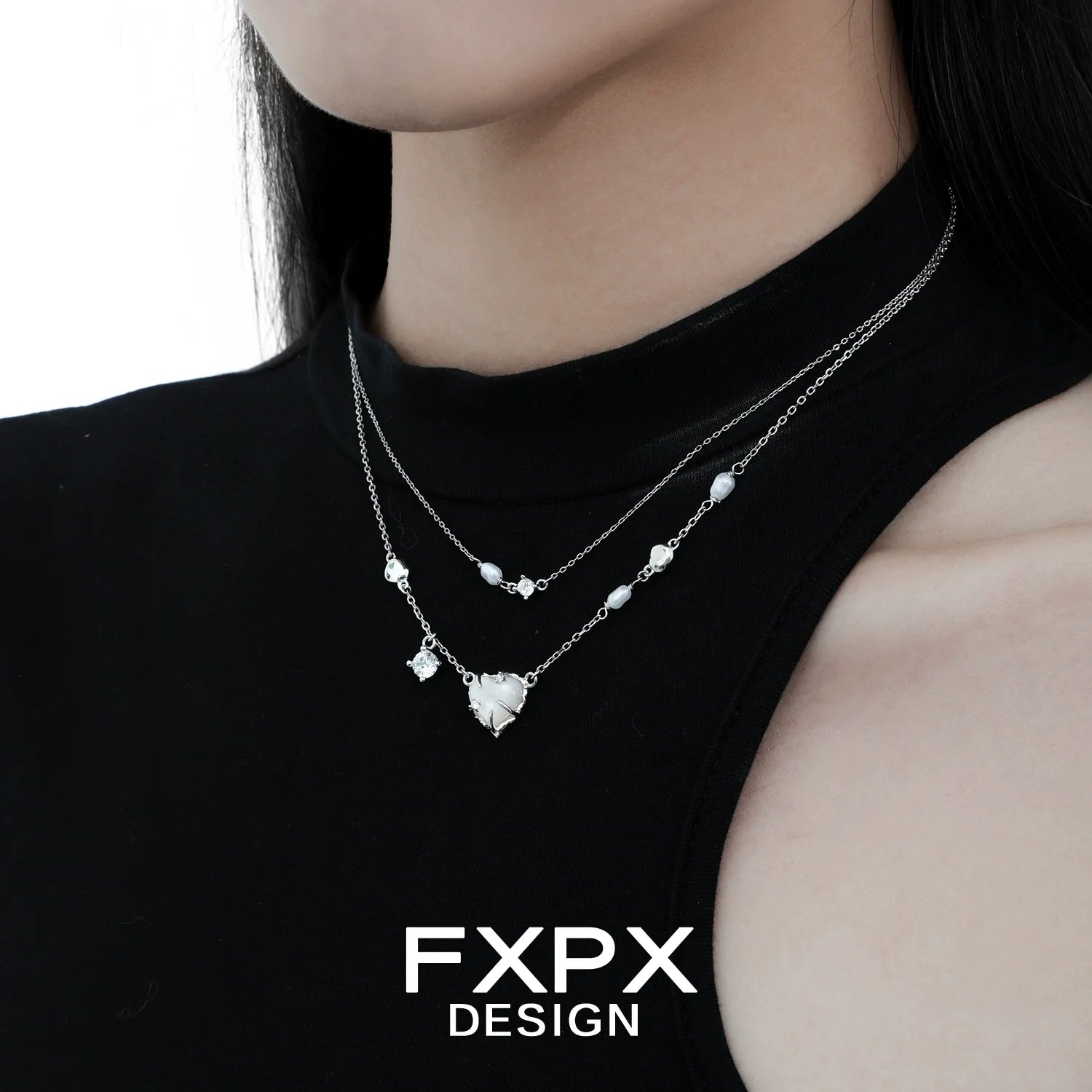 Double layer silver love necklace featuring delicate heart and bead accents on a model's neck