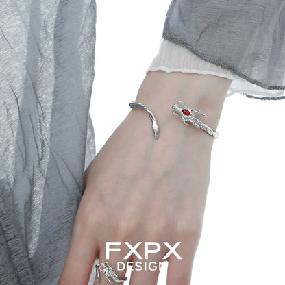 FXPX dragon guardian silver bracelet featuring intricate design and red gemstone accent