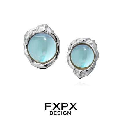 FXPX dream moonlight stud earrings with a silver textured design and luminous blue gemstones