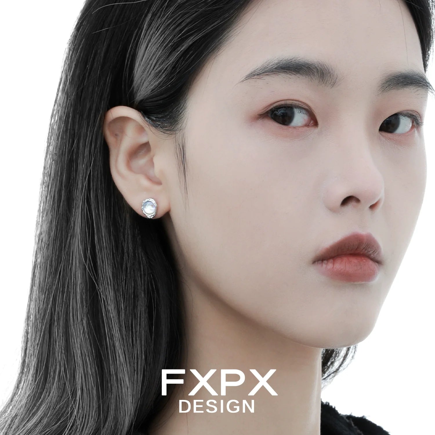 Model wearing FXPX dream moonlight stud earrings with sparkling gemstone detail