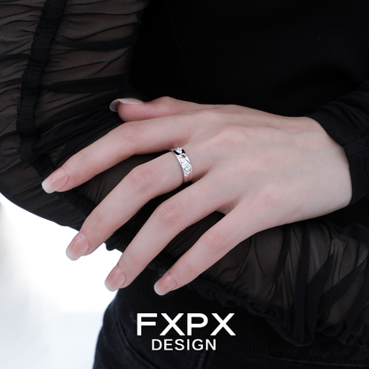 Elegant FXPX fractured texture silver ring displayed on a model's hand with stylish attire