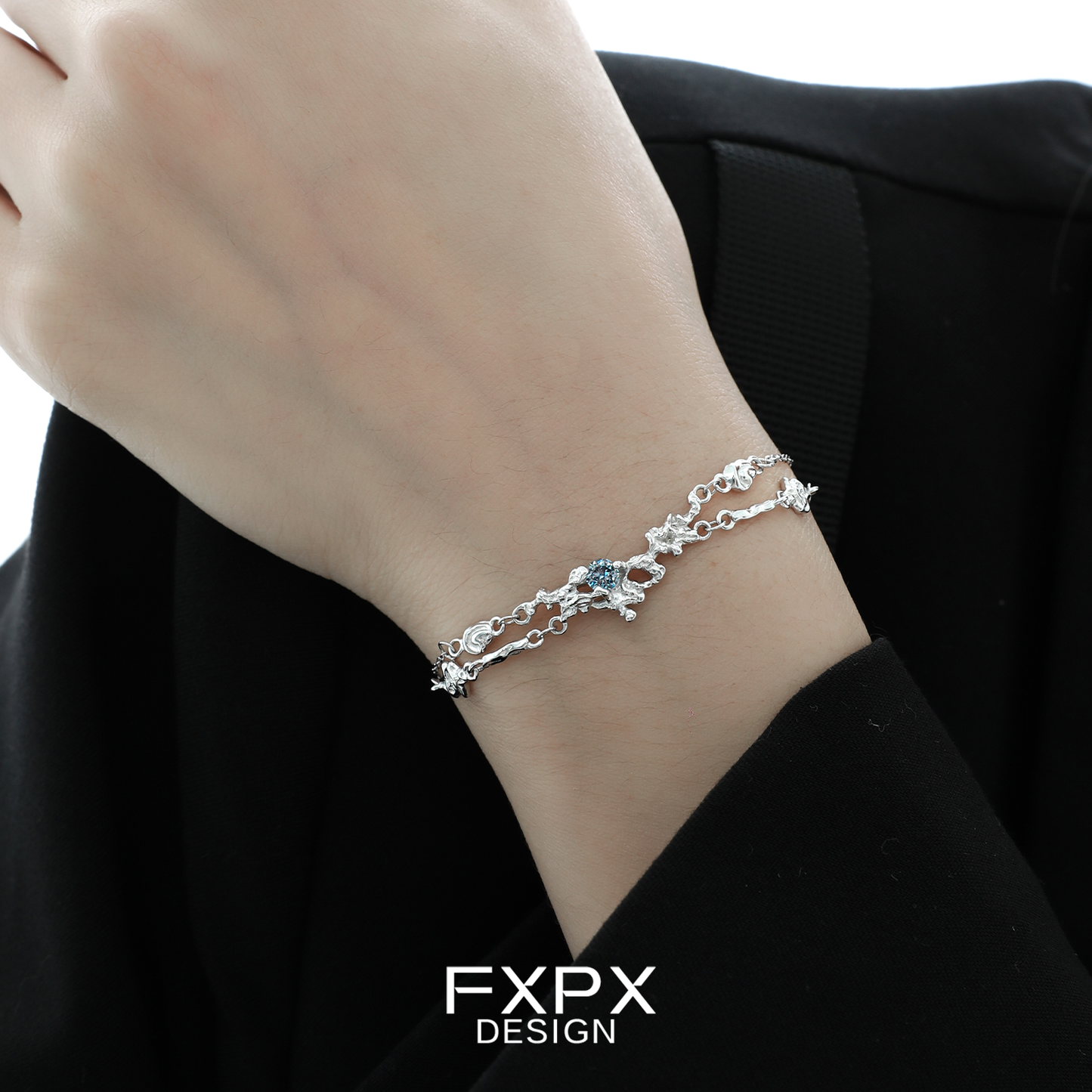 Elegant FXPX frost blue zircon bracelet elegantly worn on a wrist with delicate silver accents