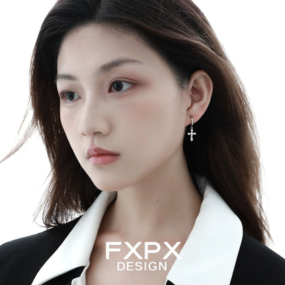 Frosted cross zircon earrings displayed on a model with a stylish black outfit