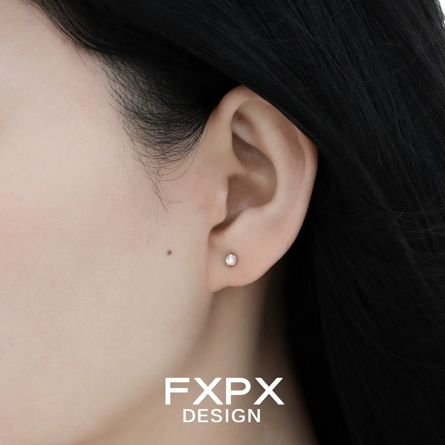 Frosted white agate stud earrings showcased on a model's ear for elegant style