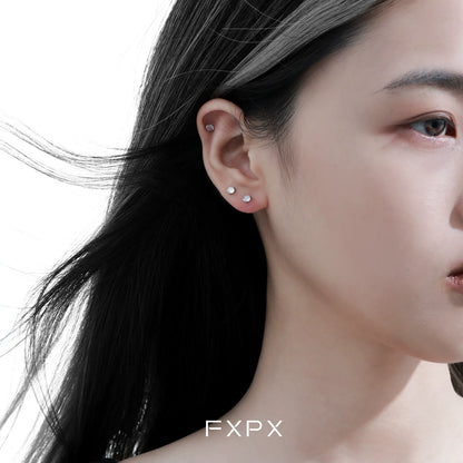 Frosted white agate stud earrings displayed on a model with dark hair and a subtle smile