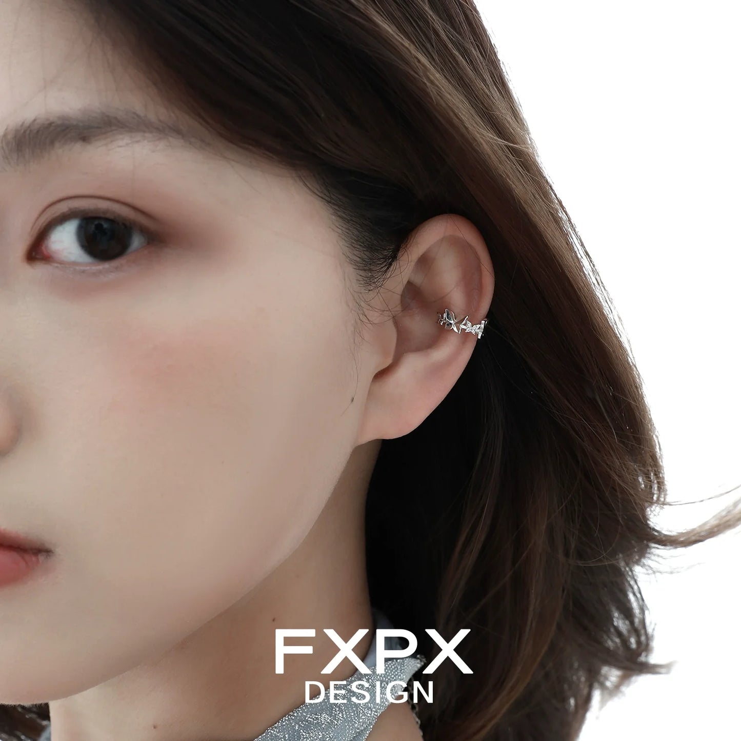 Stylish model wearing a futuristic butterfly ear cuff showcasing a unique design