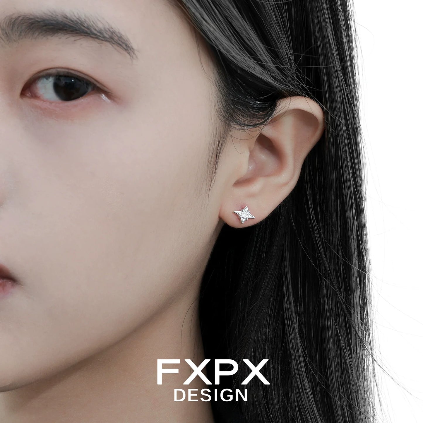 Geometric star cross stud earrings showcased on a model's ear for stylish accessorizing