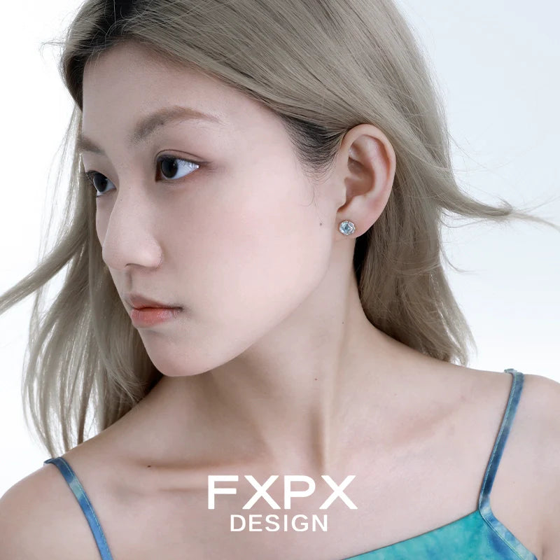 FXPX glacier drop earrings elegantly complementing a model's look with a soft hairstyle