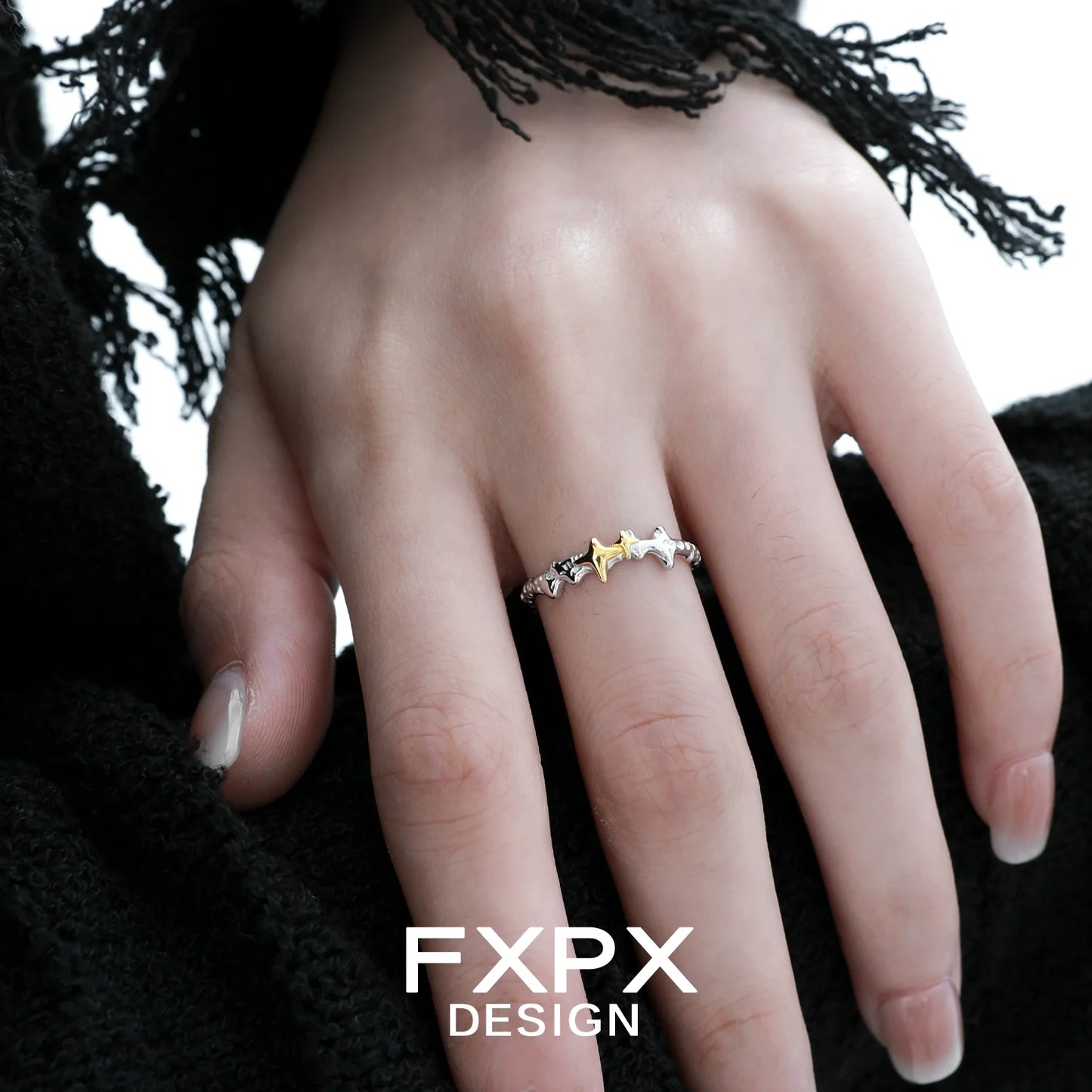 FXPX gold star ring featuring multiple star shapes in a stylish design on a model's hand