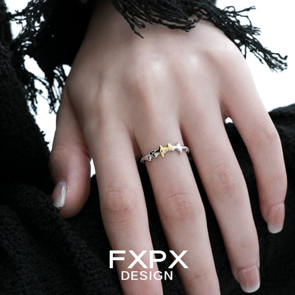 FXPX gold star ring featuring multiple star shapes in a stylish design on a model's hand