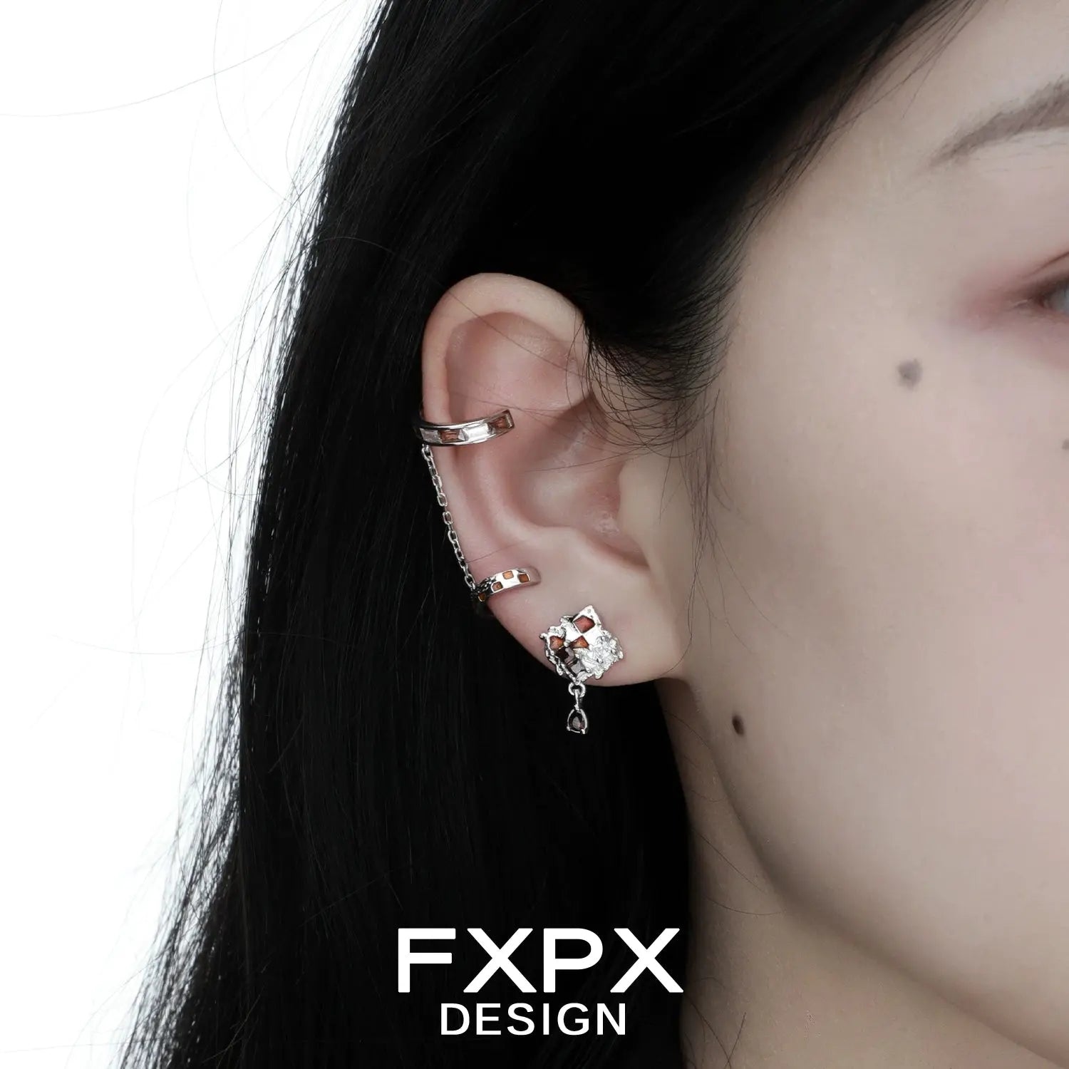 Gothhalo jewelry checkerboard ear cuff with chain and stud worn on a model's ear by FXPX