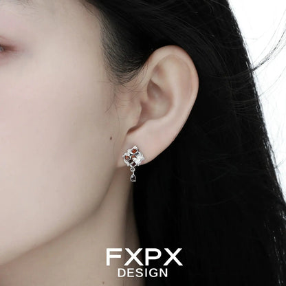 Gothhalo jewelry gothic checkerboard earrings worn on ear with silver and red detailing