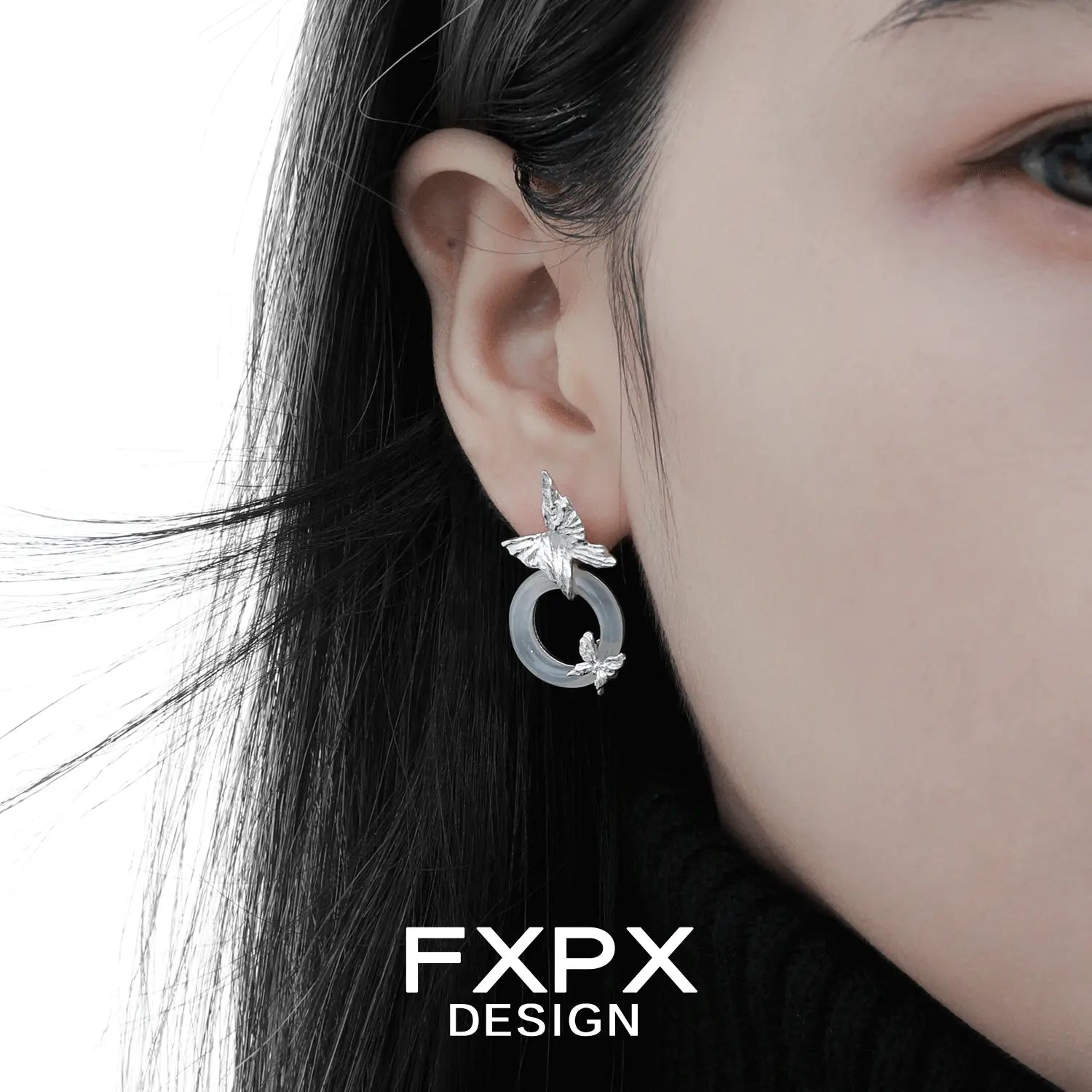FXPX Gothhalo jewelry modern butterfly hoop earrings worn on ear with silver butterfly design