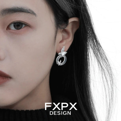 FXPX Gothhalo jewelry modern butterfly hoop earrings worn on model's left ear in silver tone