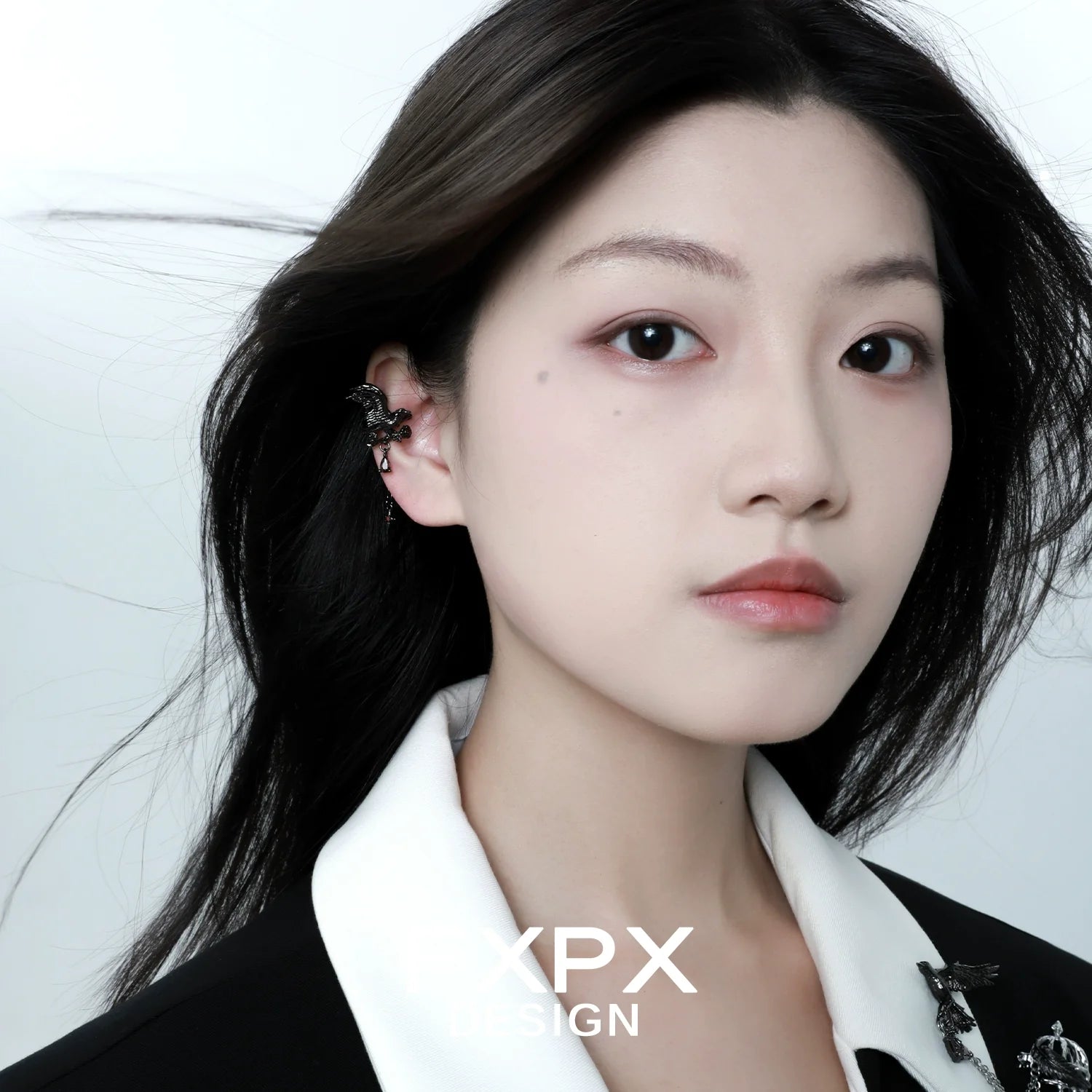 FXPX gothic crow ear cuffs displayed on a model with long dark hair and a stylish outfit