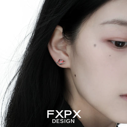 FXPX gothic heart earrings in silver with a delicate design showcased on a model's ear