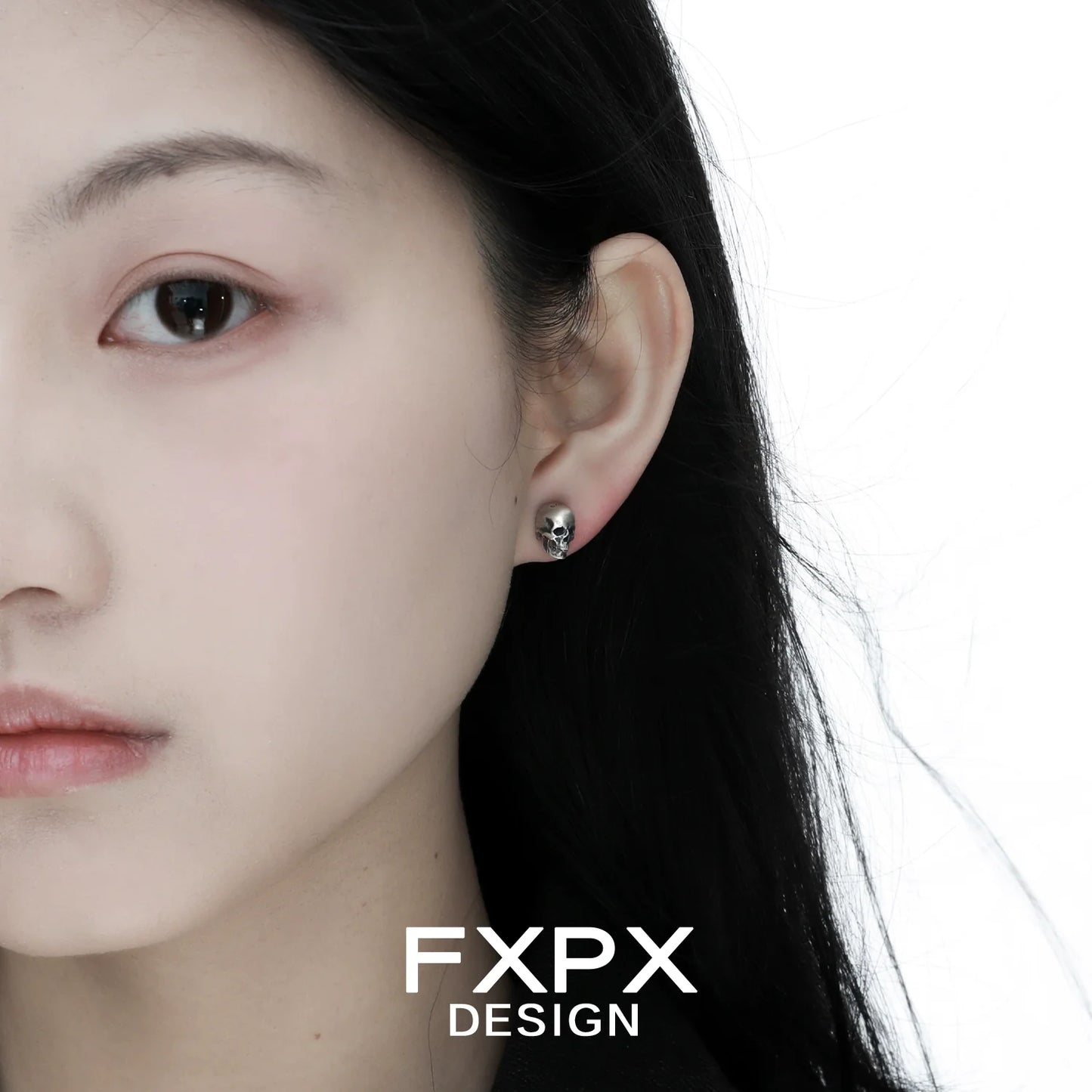 Model wearing gothic skull silver earrings showcasing a unique and edgy design