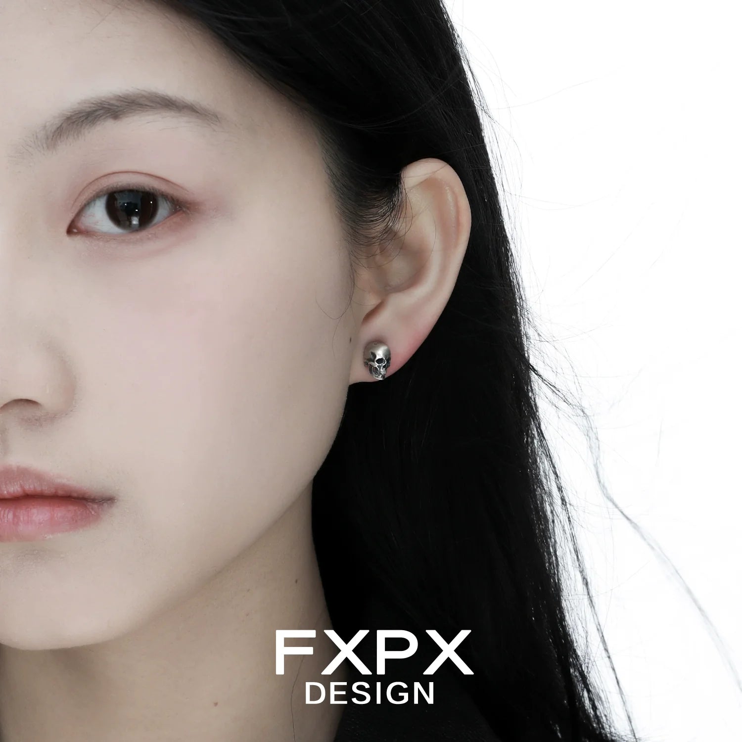 Model wearing gothic skull silver earrings showcasing a unique and edgy design