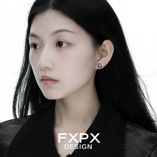 FXPX Gothic Skull Silver Earrings showcased on model with long black hair and minimalist style
