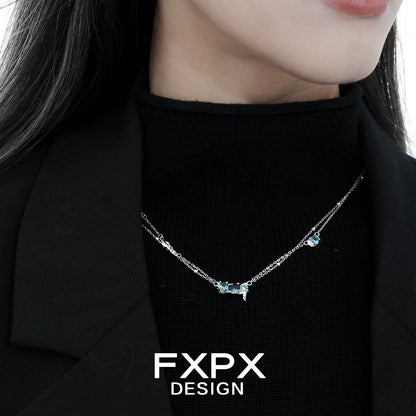Elegant FXPX Icelandic blue zircon necklace showcasing sparkling blue gemstones on a silver chain