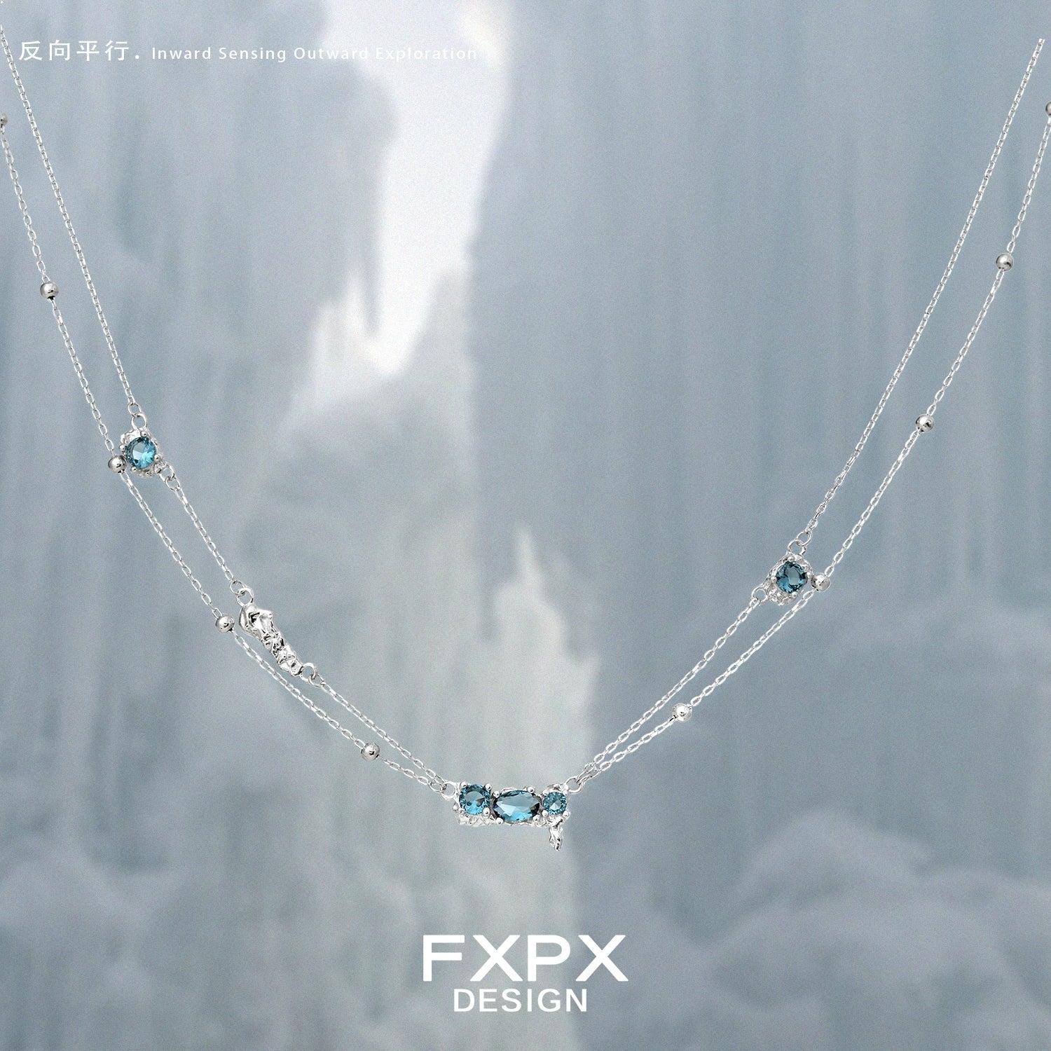 FXPX Icelandic blue zircon necklace with a delicate silver chain and sparkling blue gemstones