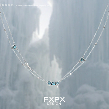 FXPX Icelandic blue zircon necklace with a delicate silver chain and sparkling blue gemstones