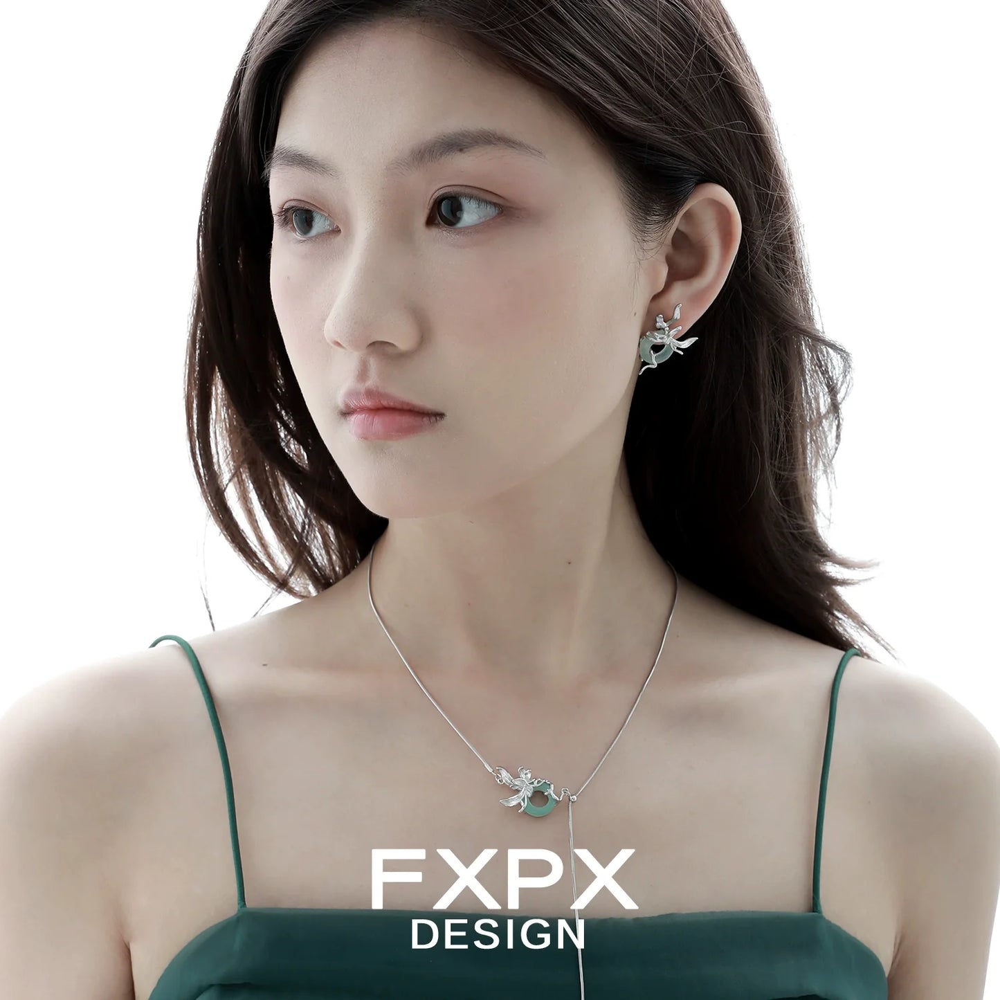 Elegant model showcasing FXPX Iris safety buckle necklace with matching earrings for stylish accessorizing