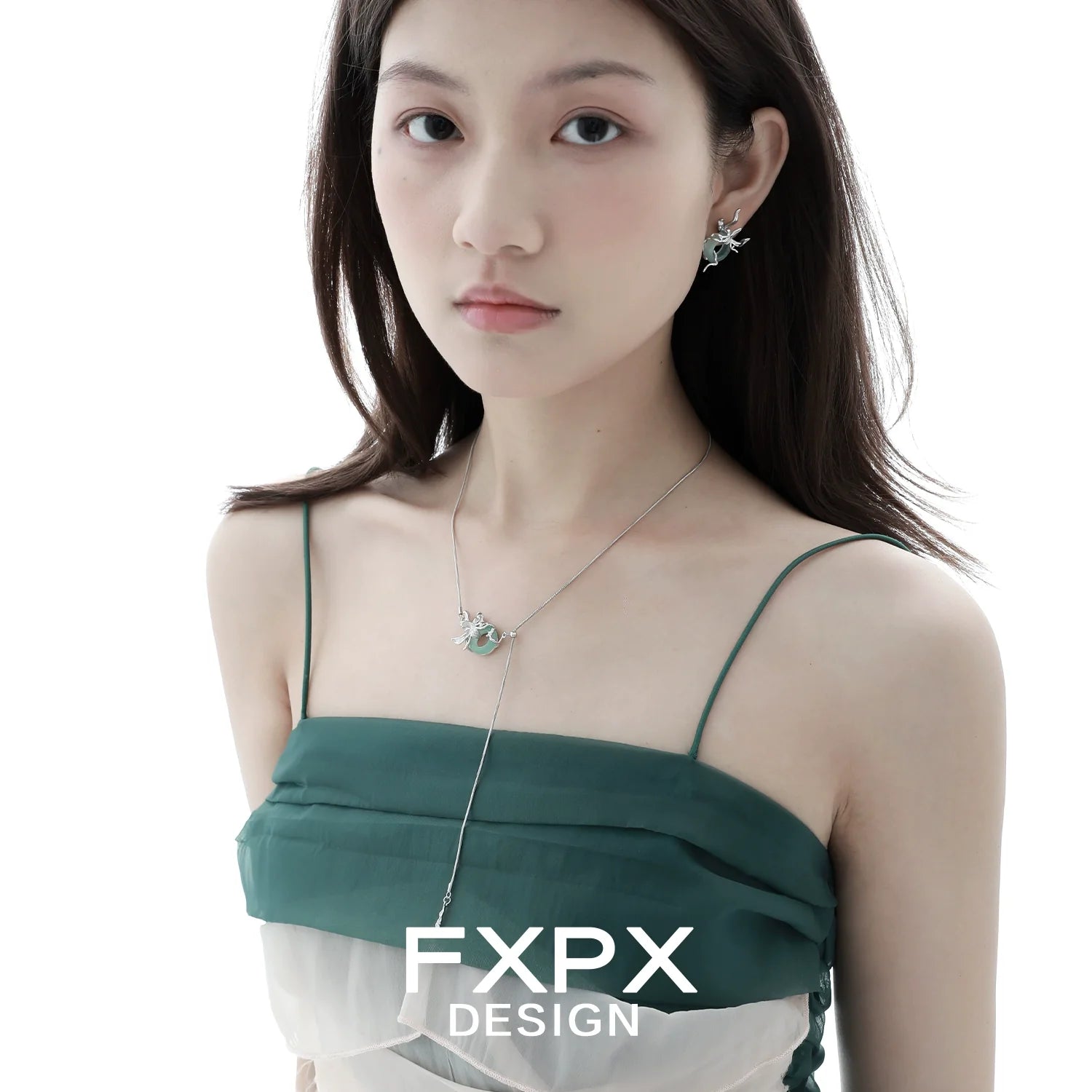 Iris safety buckle necklace worn by model with elegant green dress and stylish earrings