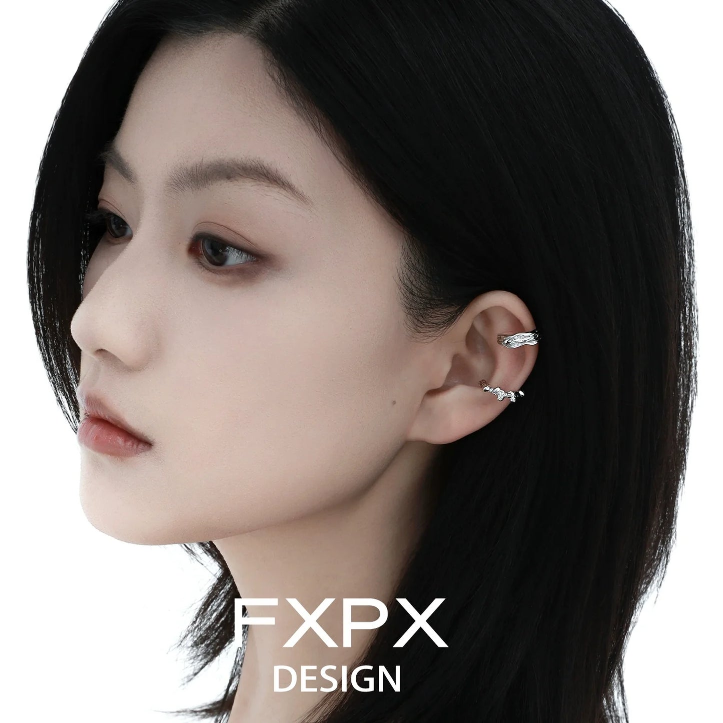 Elegant irregular silver earrings showcased on a model's ear for a stylish look