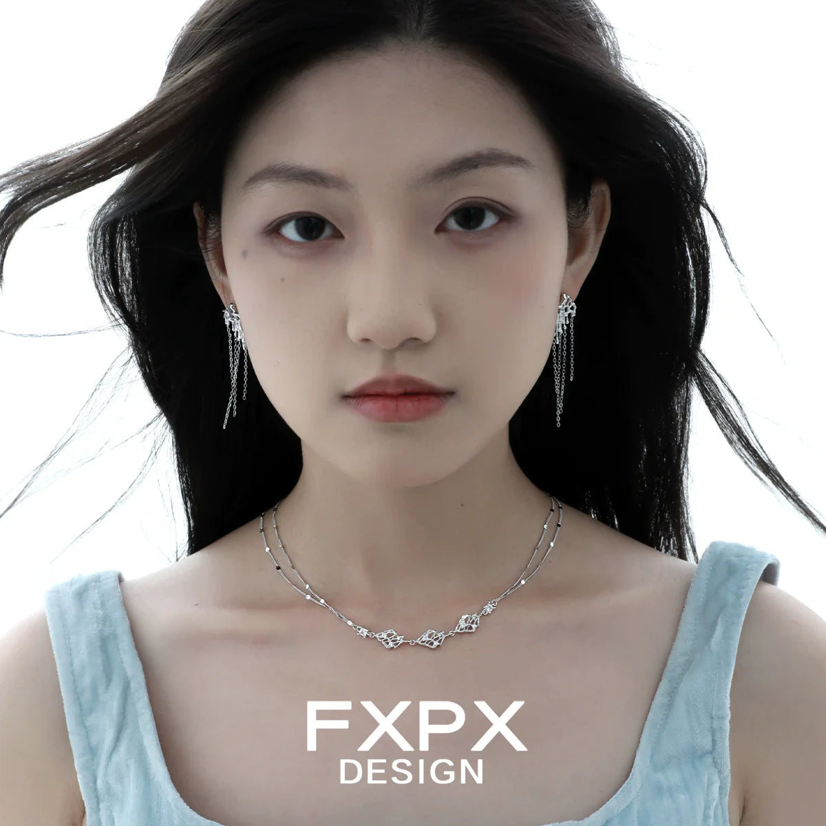 Layered silver gothic necklace by FXPX worn by a model with matching earrings