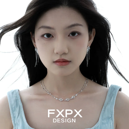 Layered silver gothic necklace by FXPX worn by a model with matching earrings
