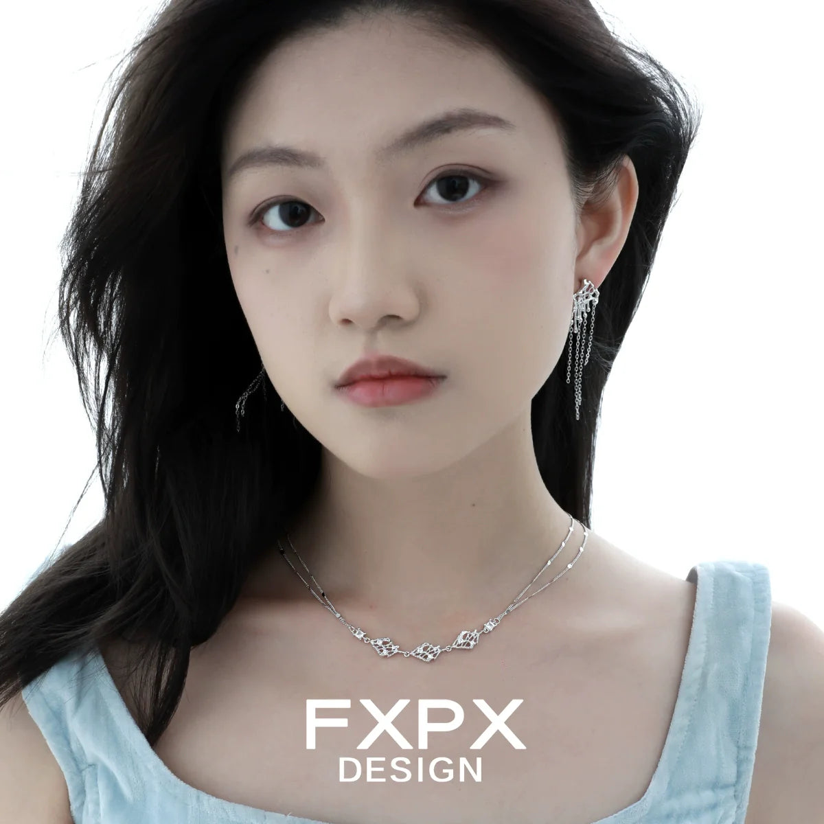 Layered silver gothic necklace with intricate design, worn by a model showcasing stylish jewelry