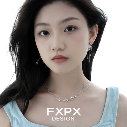Layered silver gothic necklace with intricate design, worn by a model showcasing stylish jewelry