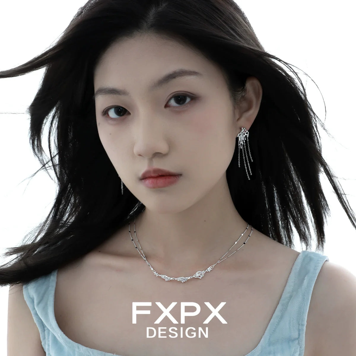Layered silver gothic necklace displayed on model with long hair and soft expression