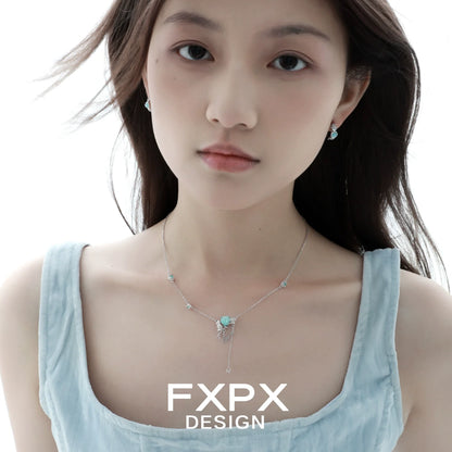Light blue rose pendant necklace from FXPX showcased on a model with matching earrings