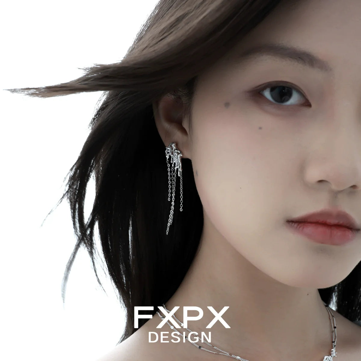 Stylish liquid metal tassel earrings dangling elegantly on a model's ear for a chic look