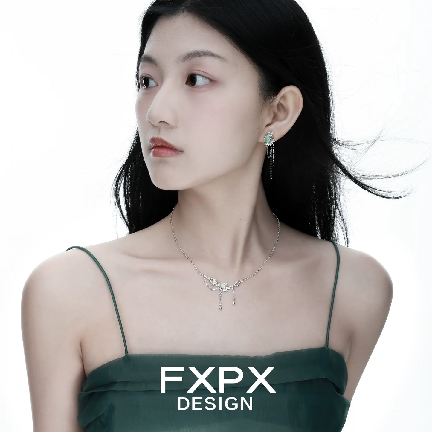 Elegant FXPX lotus pendant necklace displayed on a model with flowing hair and a stylish dress